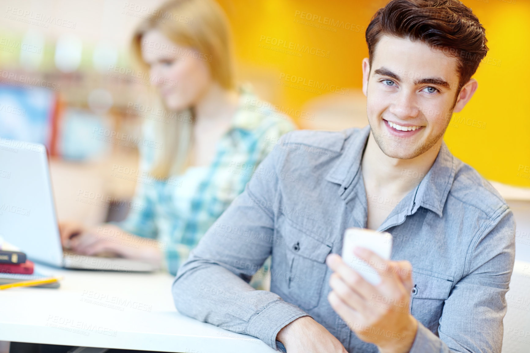 Buy stock photo Education, phone and portrait of student man in library at college or university campus for learning. Development, social media and study with happy person at school desk or table for scholarship