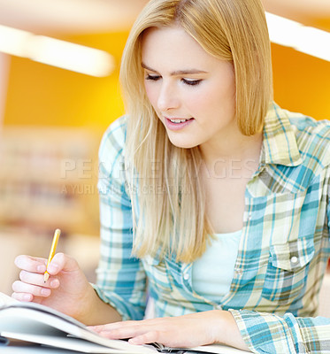 Buy stock photo Girl, college student and reading with book at library for research, learning and development. Person, woman and ideas at university, campus and review for info, scholarship and studying in Germany