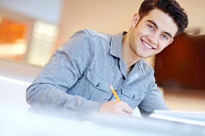 Buy stock photo Man, student and happy for education with studying on portrait for exams, assessment and test in France. Male person, high school learner and smile or satisfied with notes at library for learning