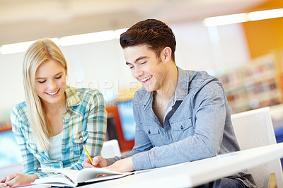 Buy stock photo Education, smile and writing with student friends in library at college or university campus for learning. Development, notebook and study with happy people at school desk for scholarship together