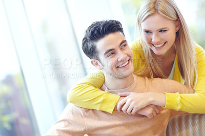 Buy stock photo Smile, couple and hug in home for support, connection and relax together for love. Happy man, woman and embrace in living room for healthy relationship, trust and commitment to partner for marriage