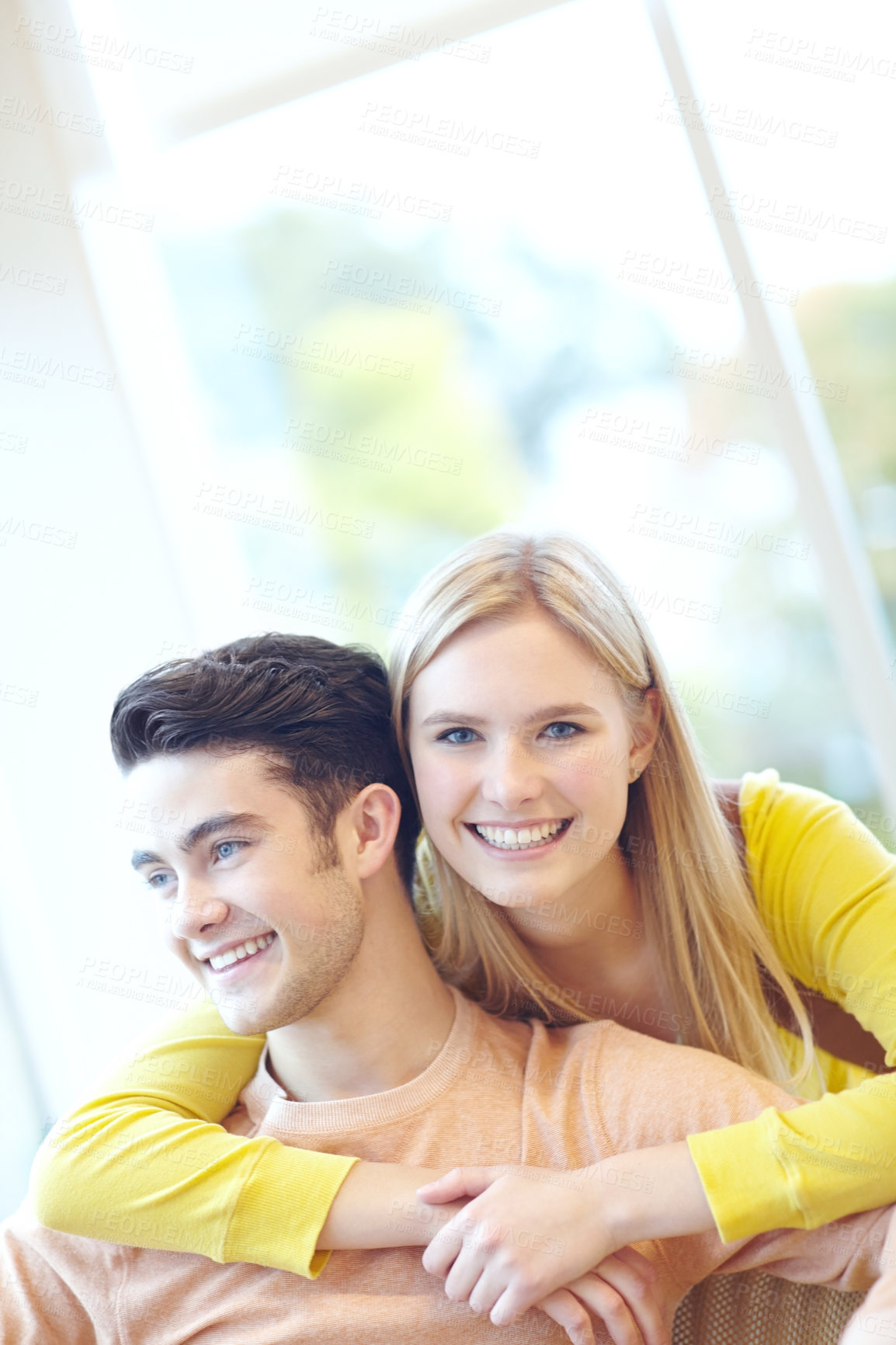 Buy stock photo Love, embrace and happy couple in home for support, connection and relax together. Smile, man and woman hug in living room for healthy relationship, marriage and commitment to partner for loyalty