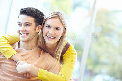 Buy stock photo Smile, couple and hug in home for love, connection and laugh to relax together. Happy man, woman and embrace in living room for healthy relationship, trust and commitment to funny partner for support