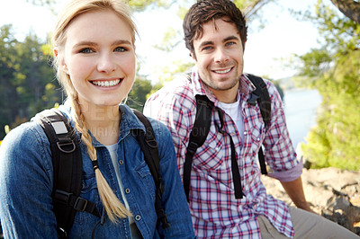 Buy stock photo Portrait, relax or happy couple hiking by lake for travel, outdoor adventure or journey in nature with smile. Laugh, resting or people in forest on holiday vacation, fun trip or river to explore park