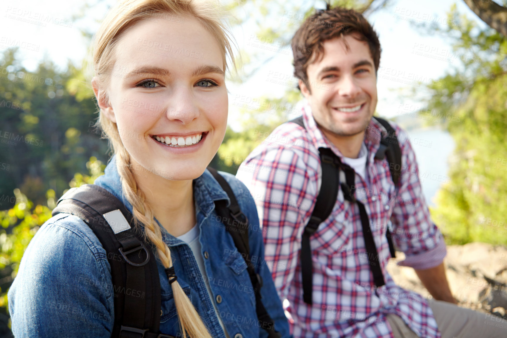 Buy stock photo Portrait, break or happy couple hiking by lake for travel, outdoor adventure or journey in nature with smile. Relax, resting or people in forest on holiday vacation, fun trip or river to explore park