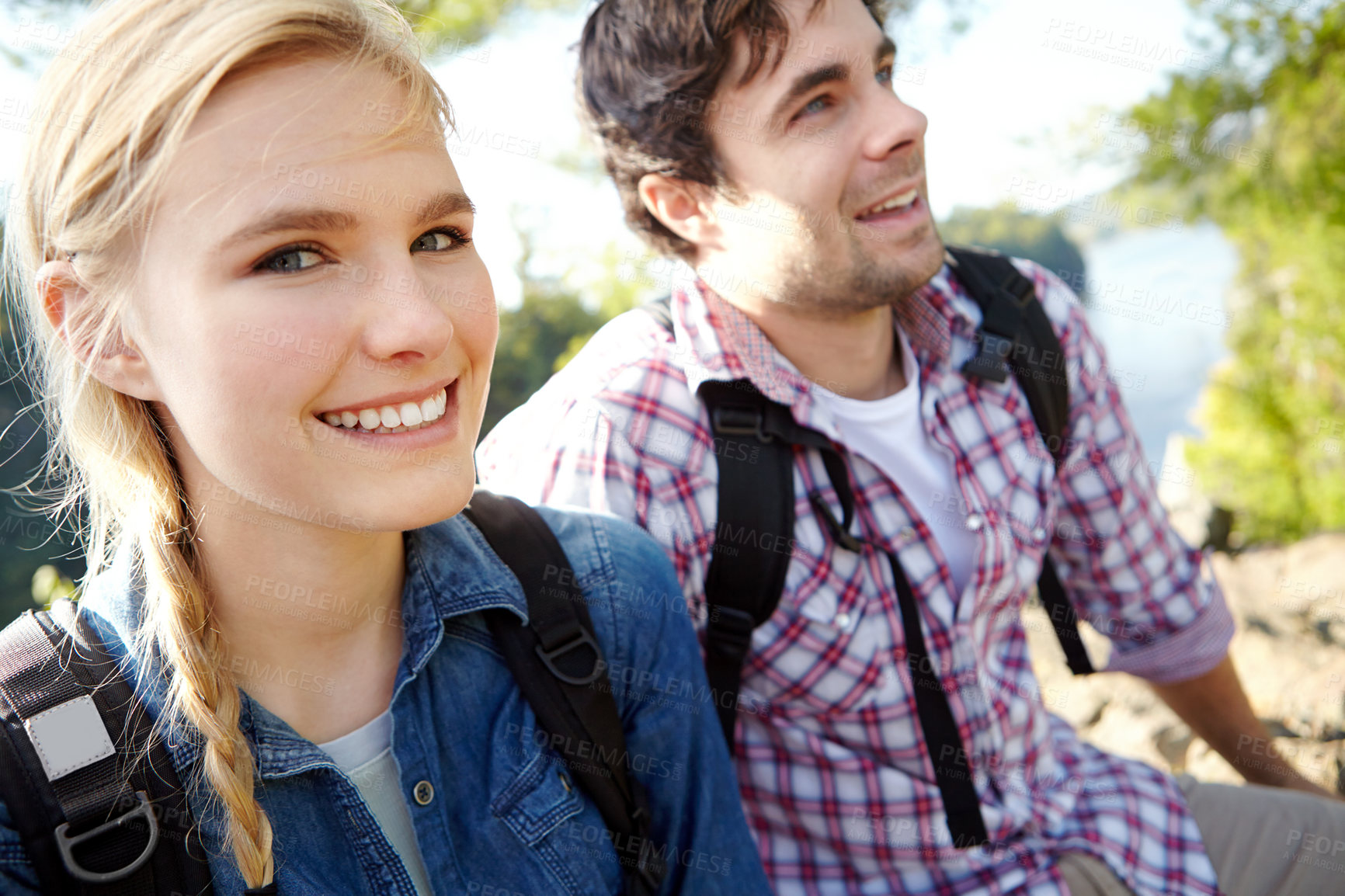 Buy stock photo Woods, portrait or happy couple hiking by lake for travel, outdoor adventure or journey in nature to relax. Smile, break or people in forest on holiday vacation, scenic trip or river to explore park