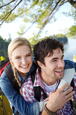 Buy stock photo Portrait, hug and couple hiking by lake for travel, outdoor adventure or journey in nature together. Romantic, woods or people resting to relax on holiday vacation to explore forest or park for break