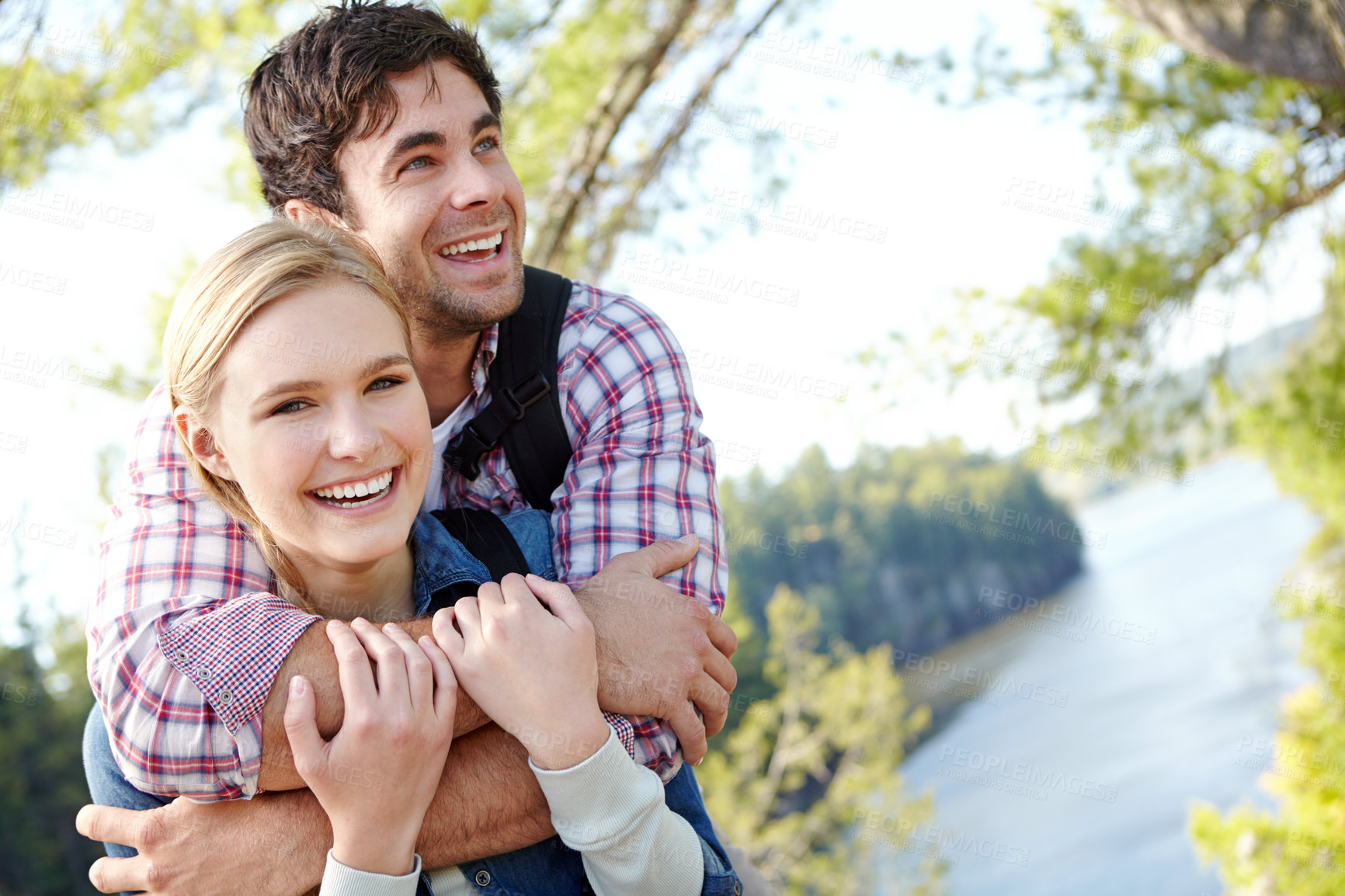 Buy stock photo Portrait, hug or happy couple by river in woods for travel, outdoor adventure or hiking in nature together. Love, forest or people resting to relax on holiday vacation, break or trip to explore park