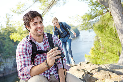 Buy stock photo Happy man, binocular or couple hiking in forest for travel, outdoor adventure or journey in woods. Mountain, view or people sightseeing in nature on holiday vacation, lake or break to explore park