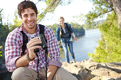 Buy stock photo Happy man, binocular or couple in portrait or forest for outdoor adventure or birdwatching in woods. Mountain, view or people sightseeing in nature on holiday vacation, lake or break to explore park