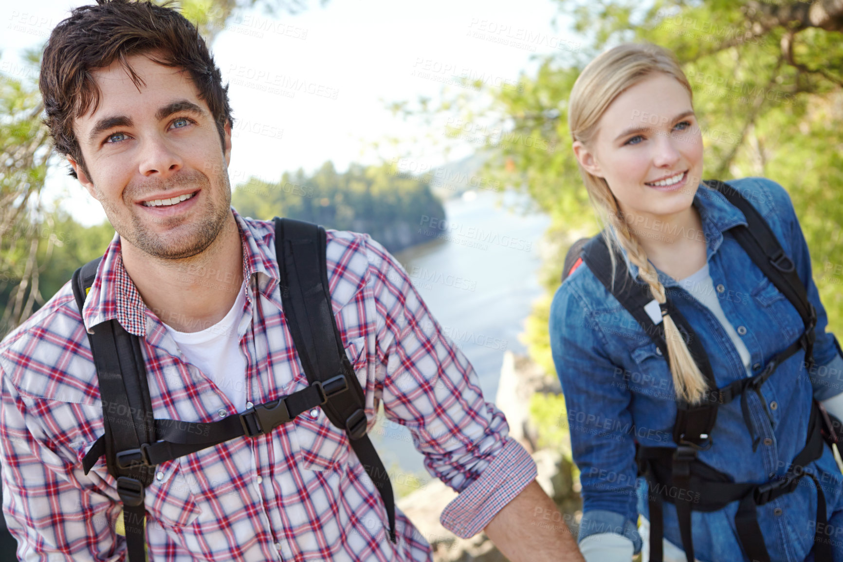 Buy stock photo Portrait, nature or happy couple hiking by river for travel, outdoor adventure or journey together. Mountain, woods or people in forest on holiday vacation, lake trip or break to explore park on hill