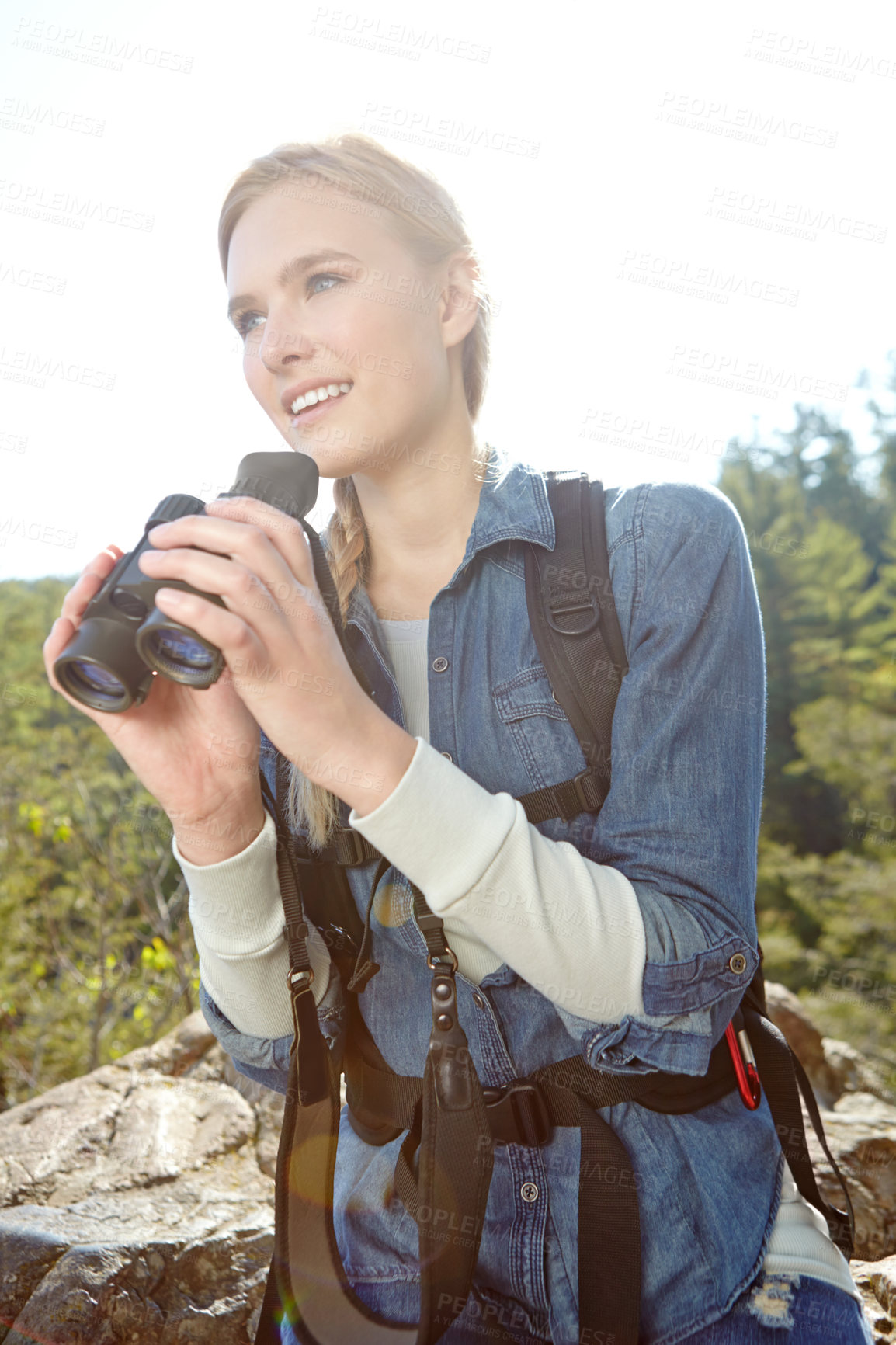 Buy stock photo Binoculars, woods and woman hiking for journey, jungle adventure and nature explore with backpack. Hiker, camper and girl trekking in forest for view, search or birdwatching outdoor Norway travel