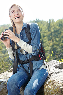 Buy stock photo Hiking, binoculars and laughing with woman in nature for wildlife biologist, field research and ecology. Wellness, travel and adventure with person for environment study, conservation and relax