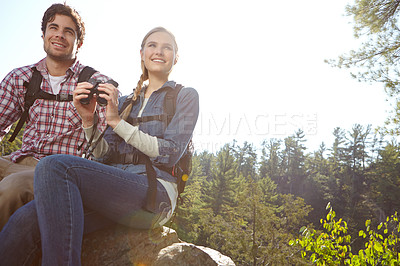 Buy stock photo Relax, binocular or happy couple hiking in mountain for travel or outdoor adventure in woods or forest. Birdwatch, view or people sightseeing in nature on holiday vacation or break to explore park