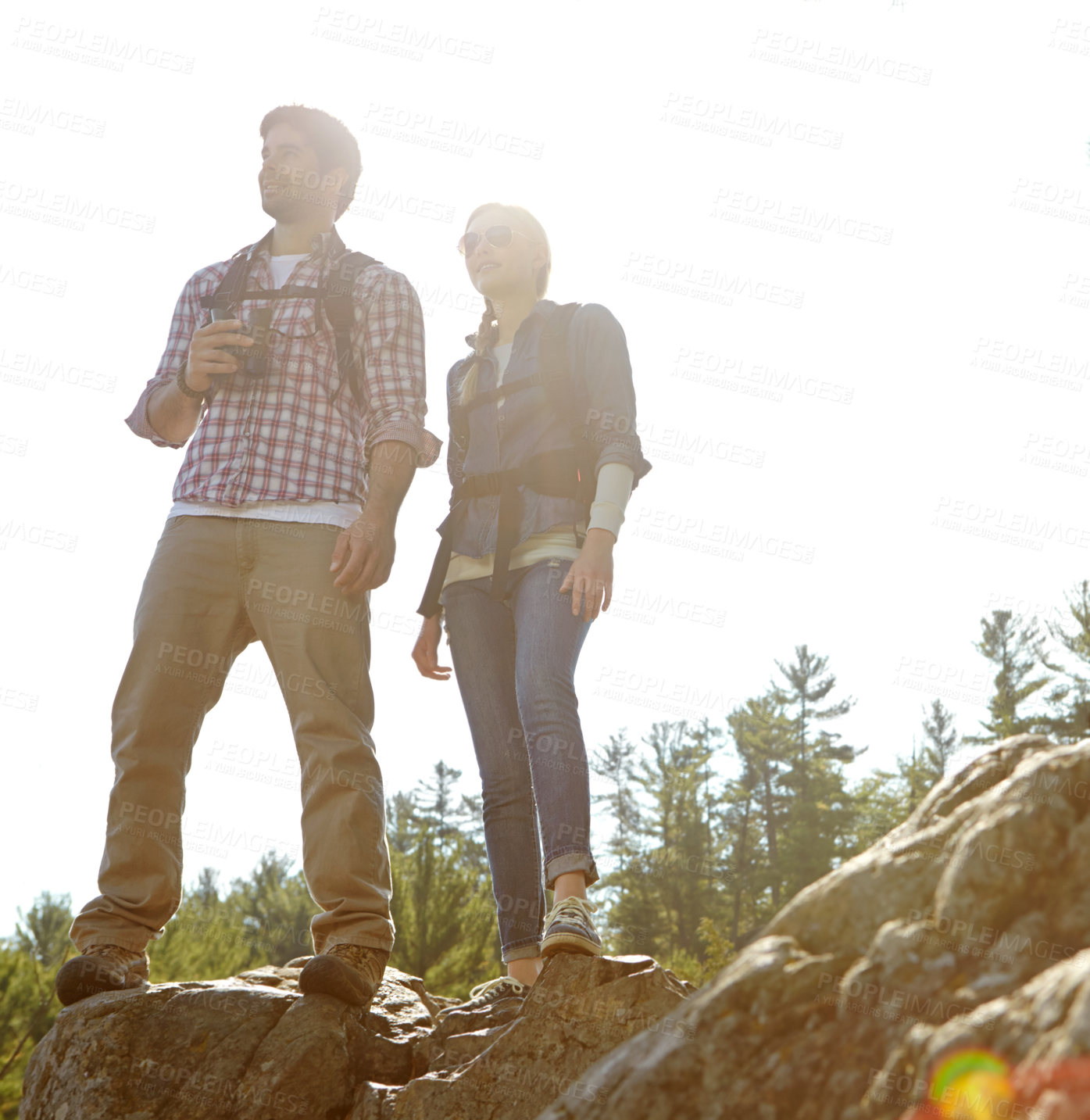 Buy stock photo Peak, binocular or couple hiking on rock or mountain for nature or outdoor adventure in woods. Forest, view or people on hill sightseeing together on holiday vacation, trip or break to explore park