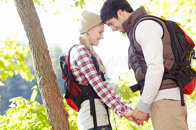 Buy stock photo Holding hands, romantic or happy couple hiking in woods for honeymoon or outdoor adventure in nature. Support, promise or people in forest together on holiday vacation, trip or break to explore park