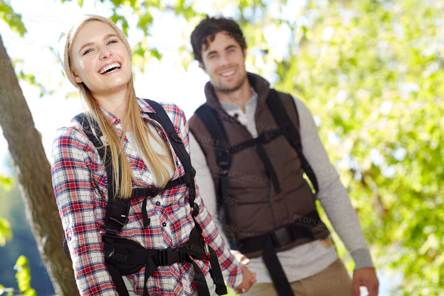 Buy stock photo Holding hands, romantic or happy couple hiking in forest for date or outdoor adventure in nature. Support, trekking or people in forest together on holiday vacation, trip or break to explore park