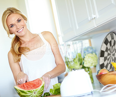 Buy stock photo Woman, happy and cut watermelon in kitchen for healthy smoothie, snack and vitamin C with detox. Female person, portrait and slice fruit in house for nutrition, gut health and diet drink with blender