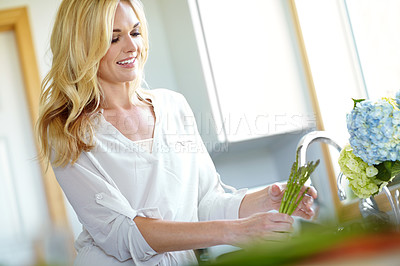 Buy stock photo Woman, happy and washing vegetables in kitchen with smile, in morning in home. Relax, wellness and cleaning for hygiene, breakfast and cooking with asparagus and meal with food, health and nutrition