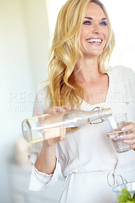 Buy stock photo Woman, glass and happy for pouring water, home or thinking with hydration, wellness or gut health. Person, smile and bottle for liquid, detox and excited with drink, thirsty or beverage at apartment