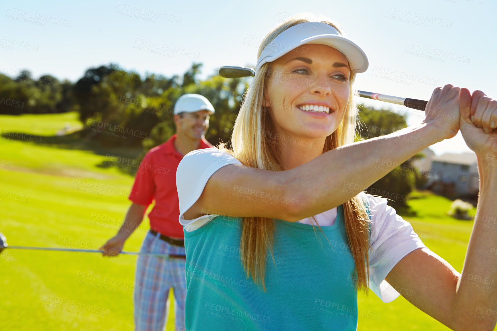 Buy stock photo Happy woman, golfer and swing with club for sports game, match or playful summer on grass field in nature. Young female person with smile or cap for golf shot, hit or challenge in outdoor activity