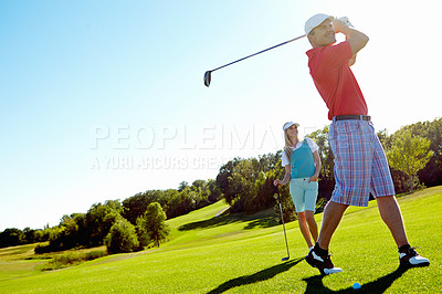 Buy stock photo Handsome man swinging his golf club