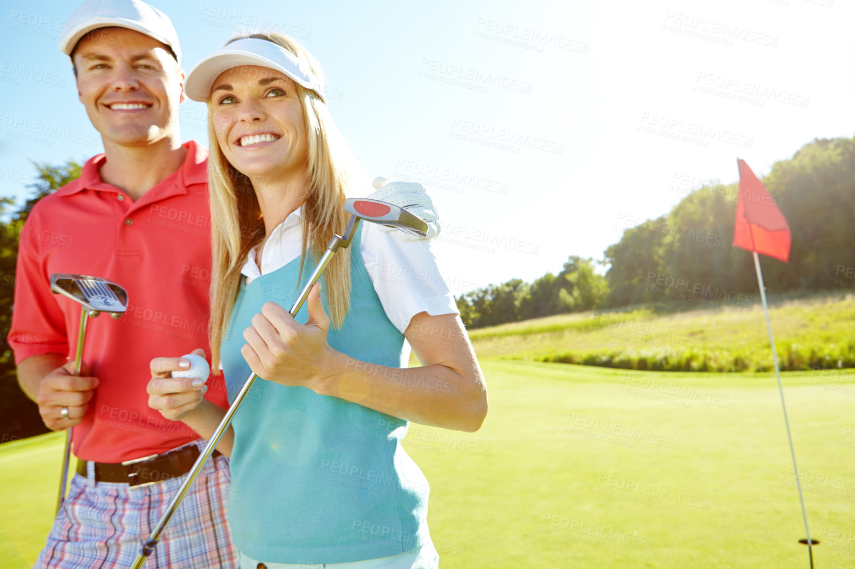 Buy stock photo Happy couple, hug and sports with golf club or ball for game or friendly outdoor match together on grass field. Young man, woman or golfers with smile for challenge, fitness or play on lawn in nature