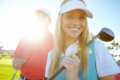 Buy stock photo Golf course, couple and club for game, fitness or weekend hobby together on vacation. Lens flare, smile and happy woman with man on green for competition, outdoor challenge and holiday sports turf