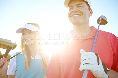 Buy stock photo Golf course, couple and club for game, exercise or weekend hobby together on vacation. Lens flare, smile and happy woman with man on green for competition, outdoor challenge and holiday sports turf