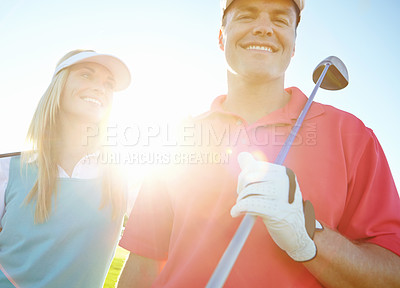 Buy stock photo Golf course, couple and smile for holiday, exercise or weekend hobby together on vacation. Lens flare, club and happy woman with man on green for competition, outdoor challenge and sports turf field