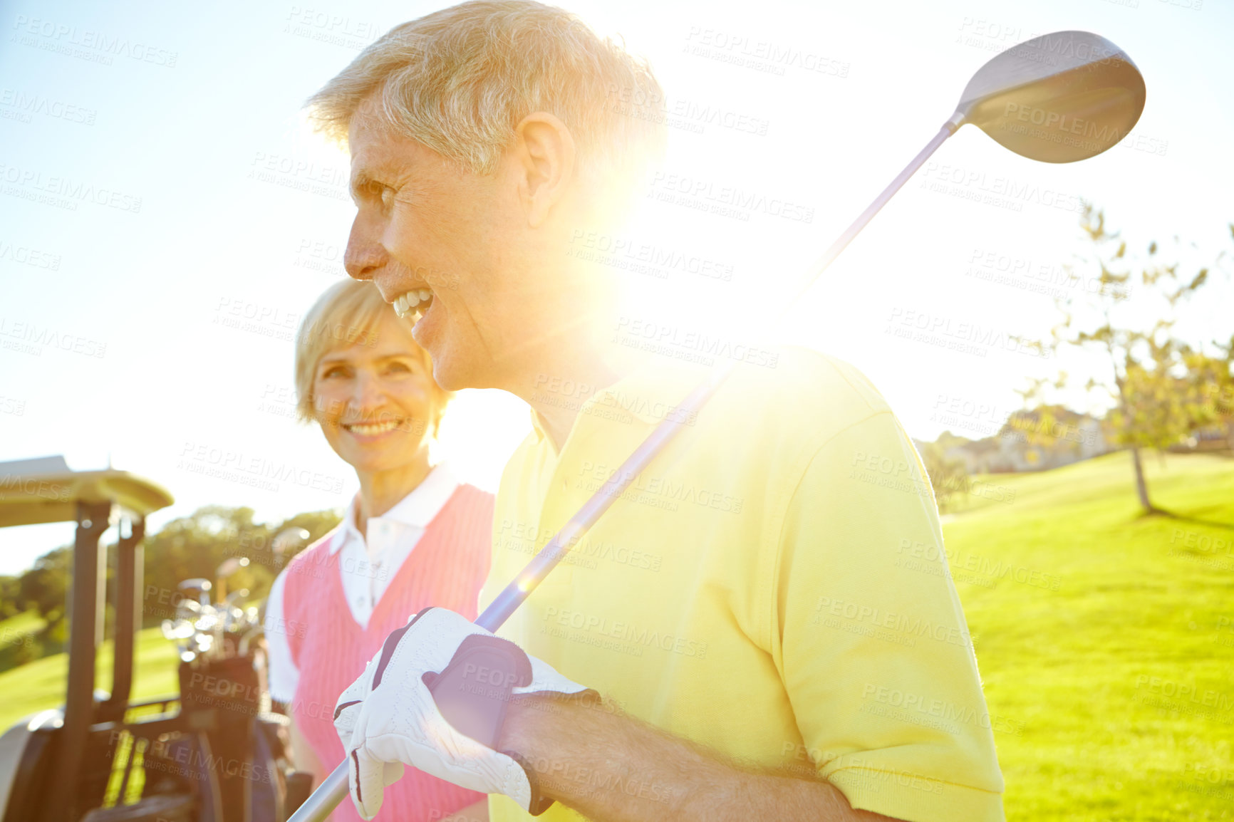 Buy stock photo Golf course, happy and senior couple with club at sunset for outdoor sports, training and bonding. Smile, man and woman with equipment in nature for retirement hobby, practice and exercise together