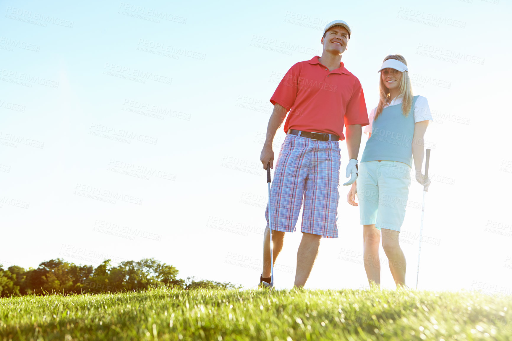 Buy stock photo Happy, smile and couple with club at golf course for outdoor sports, practice or bonding together. Low angle, man and woman with equipment in portrait for weekend hobby, exercise or training at field