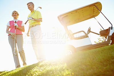 Buy stock photo Sports, golf and mature couple in morning for game, match and competition on course, field and grass. Retirement, hobby and man and woman for activity, fun and practice to relax, bonding and playing