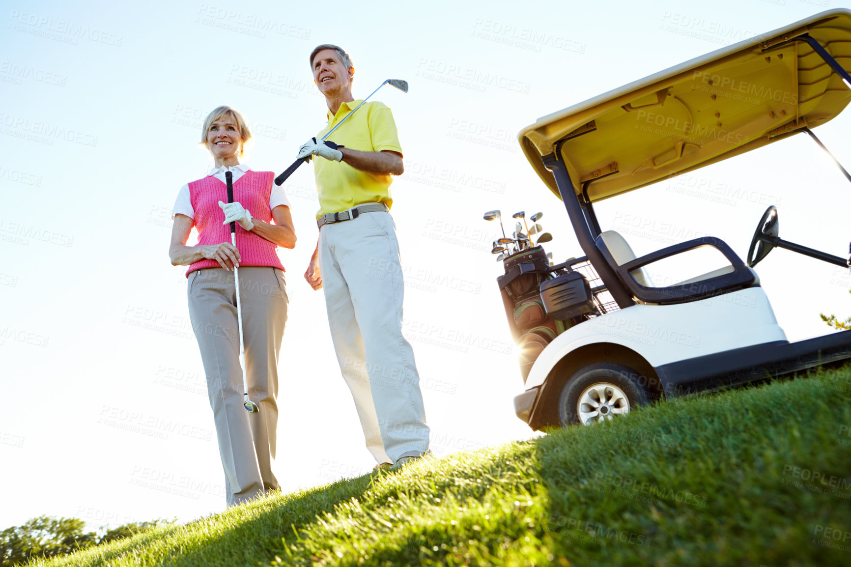 Buy stock photo Sports, cart and mature couple on golf course, field and grass for game, match and competition in morning. Retirement, hobby and man and woman for activity, fun and practice for relaxing together