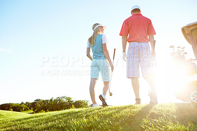 Buy stock photo Golf, sport and back of couple in morning for game, match and competition on course, field and grass. Mockup space, hobby and low angle of man and woman for playing, fun or practice together to relax