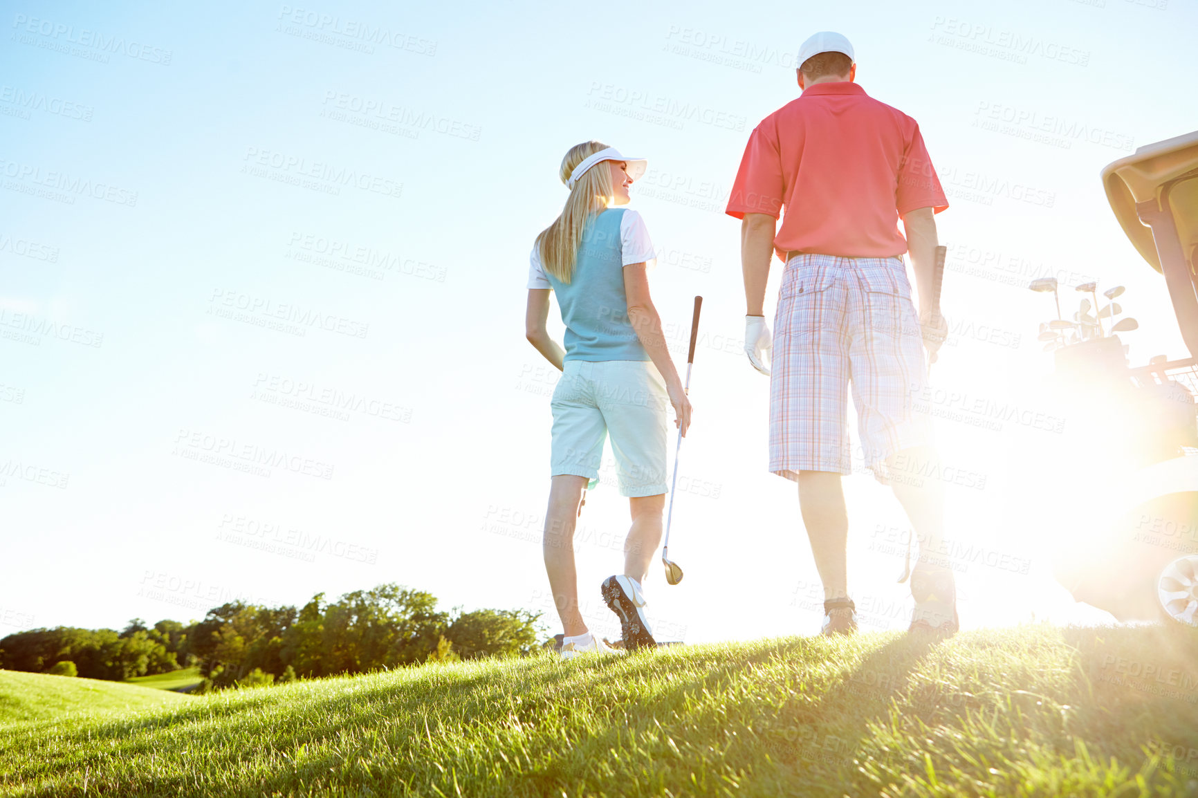 Buy stock photo Golf, sport and back of couple in morning for game, match and competition on course, field and grass. Mockup space, hobby and low angle of man and woman for playing, fun or practice together to relax