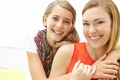 Buy stock photo Smiling mother and daughter embracing while outdoors
