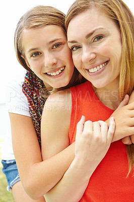 Buy stock photo Smiling mother and daughter embracing while outdoors