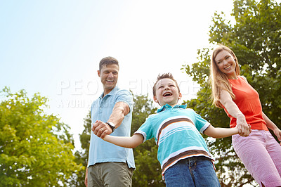 Buy stock photo Excited, family and holding hands in nature for game, swinging and playful on holiday. Kid, support and gesture in park for fun activity, energy and freedom on adventure with trust on summer vacation