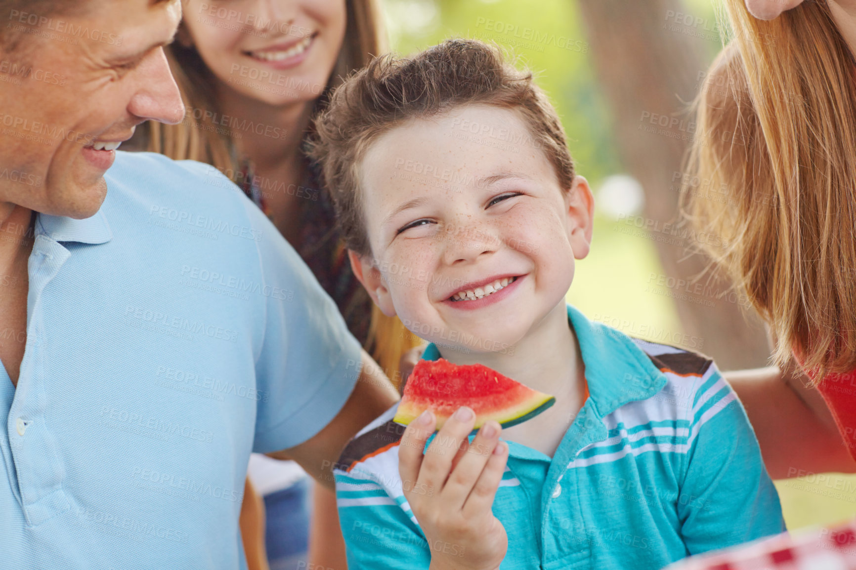 Buy stock photo Child, happy and family in nature for picnic, excited and watermelon for refreshing snack. Boy, portrait and favorite fruit in park with parents, smile and support on summer vacation in Australia