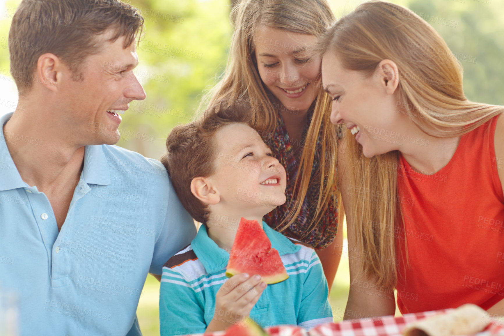 Buy stock photo Happy attractive family having a picnic in the park