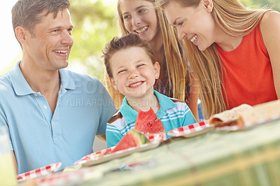 Buy stock photo Kid, happy and family in nature for picnic, excited and watermelon for refreshing snack. Boy, portrait and favorite fruit in park with parents, smile and support on summer vacation in Australia