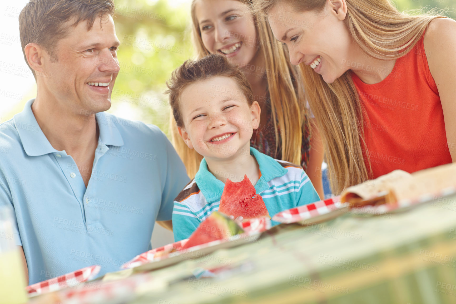 Buy stock photo Kid, happy and family in nature for picnic, excited and watermelon for refreshing snack. Boy, portrait and favorite fruit in park with parents, smile and support on summer vacation in Australia