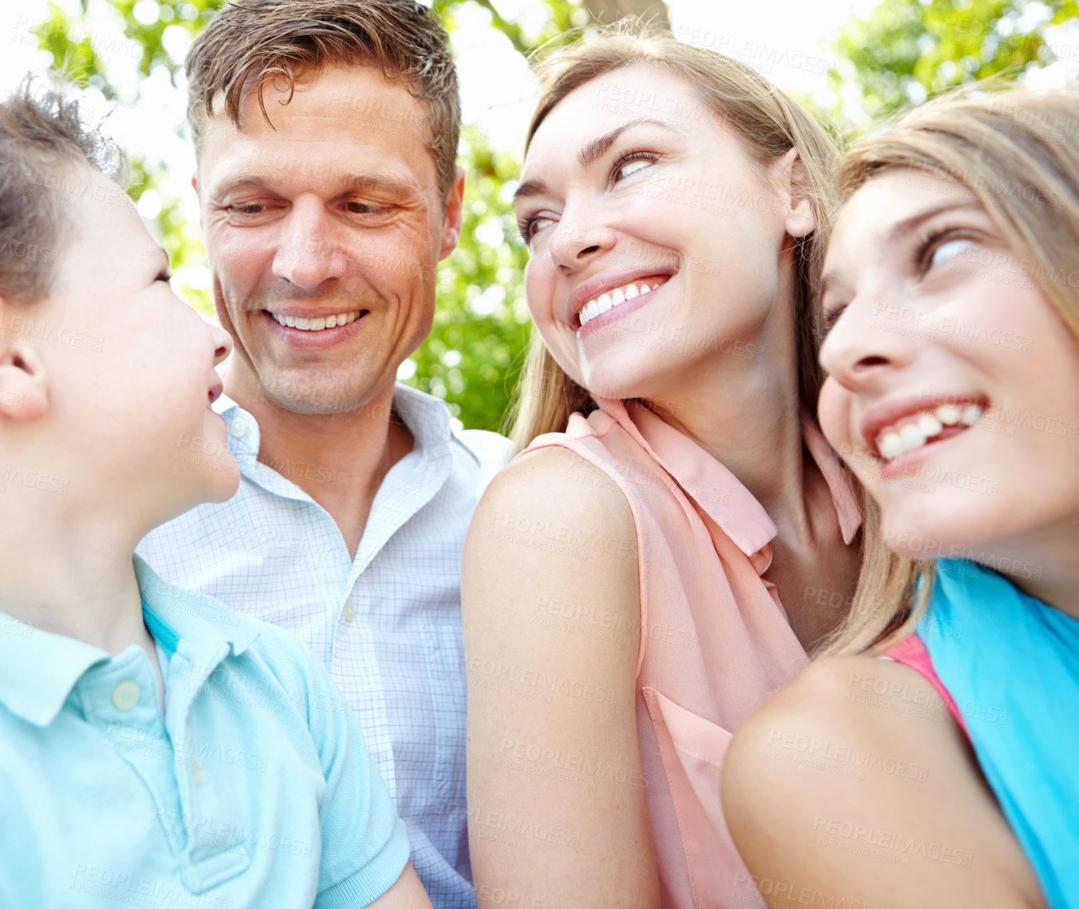 Buy stock photo Happy family smiling while outdoors