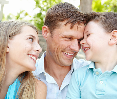 Buy stock photo Happy, father and children with forehead touch outdoor for summer vacation, relaxing and bonding together. Smile, family and kids with holiday peace for embrace, love and support of calm morning 