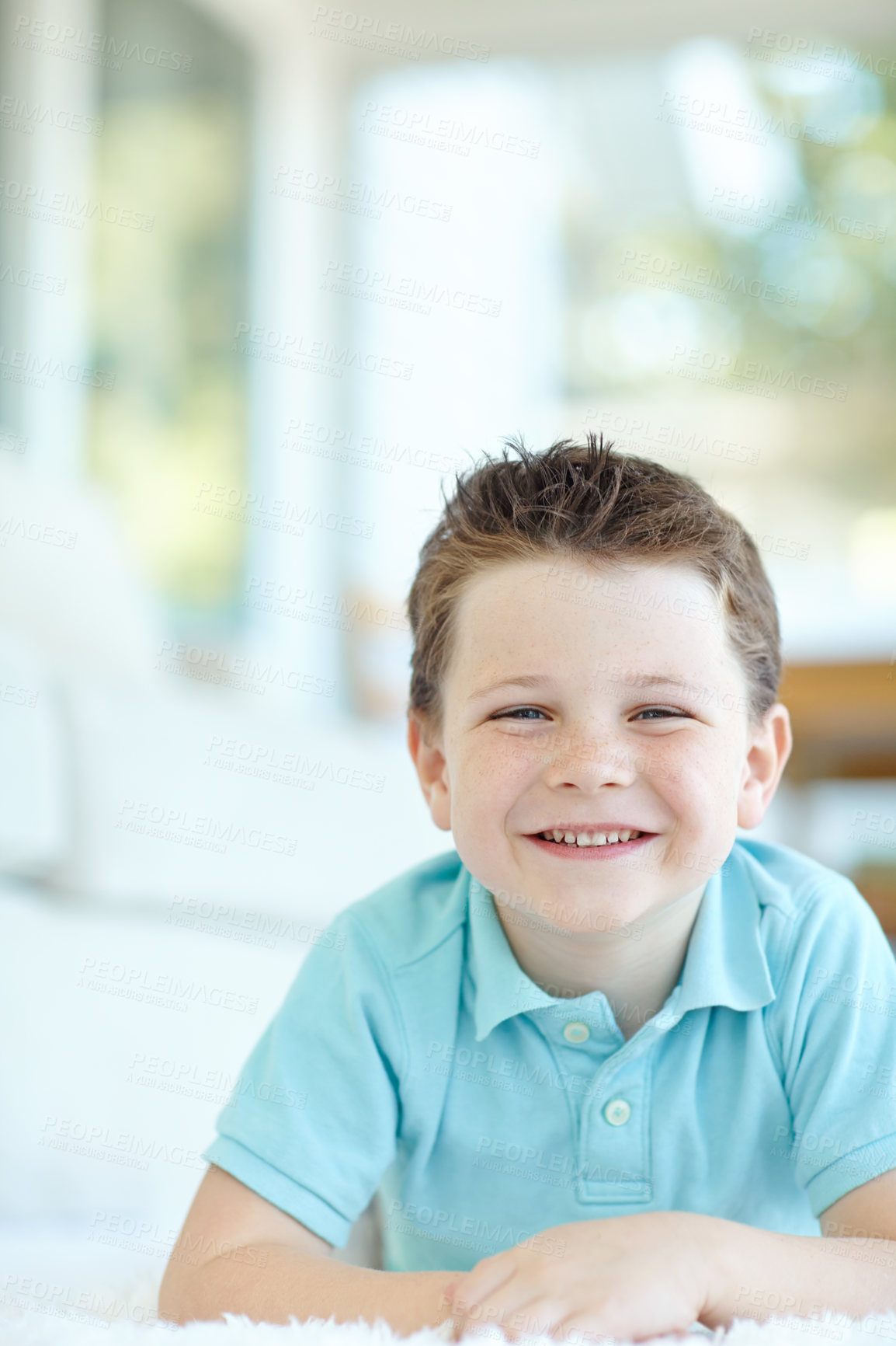 Buy stock photo Boy, happy child and lying in home portrait, morning confidence and chilling on floor of living room. Male person, kid and comfortable on carpet in France, healthy growth and development in lounge