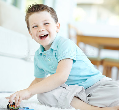 Buy stock photo Floor, boy and smile with toy cars on portrait for fun on school break at home in Scotland. Male person, kid and happy at apartment with playing for child growth, care and brain development at lounge