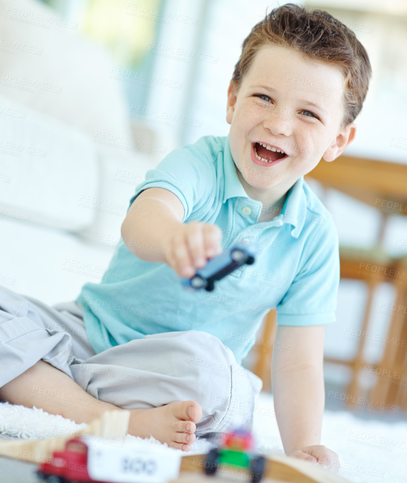 Buy stock photo Home, boy and smile with toy cars on portrait for fun on school break on floor in Scotland. Male person, kid and happy at apartment with playing for child growth, care and brain development at lounge