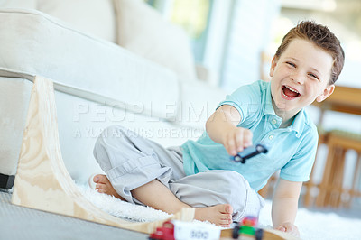 Buy stock photo Portrait, cars and kid in home playing for learning, development and fun with smile. Excited, boy and child enjoying games laughing with plastic toys for childhood hobby or growth at house in England