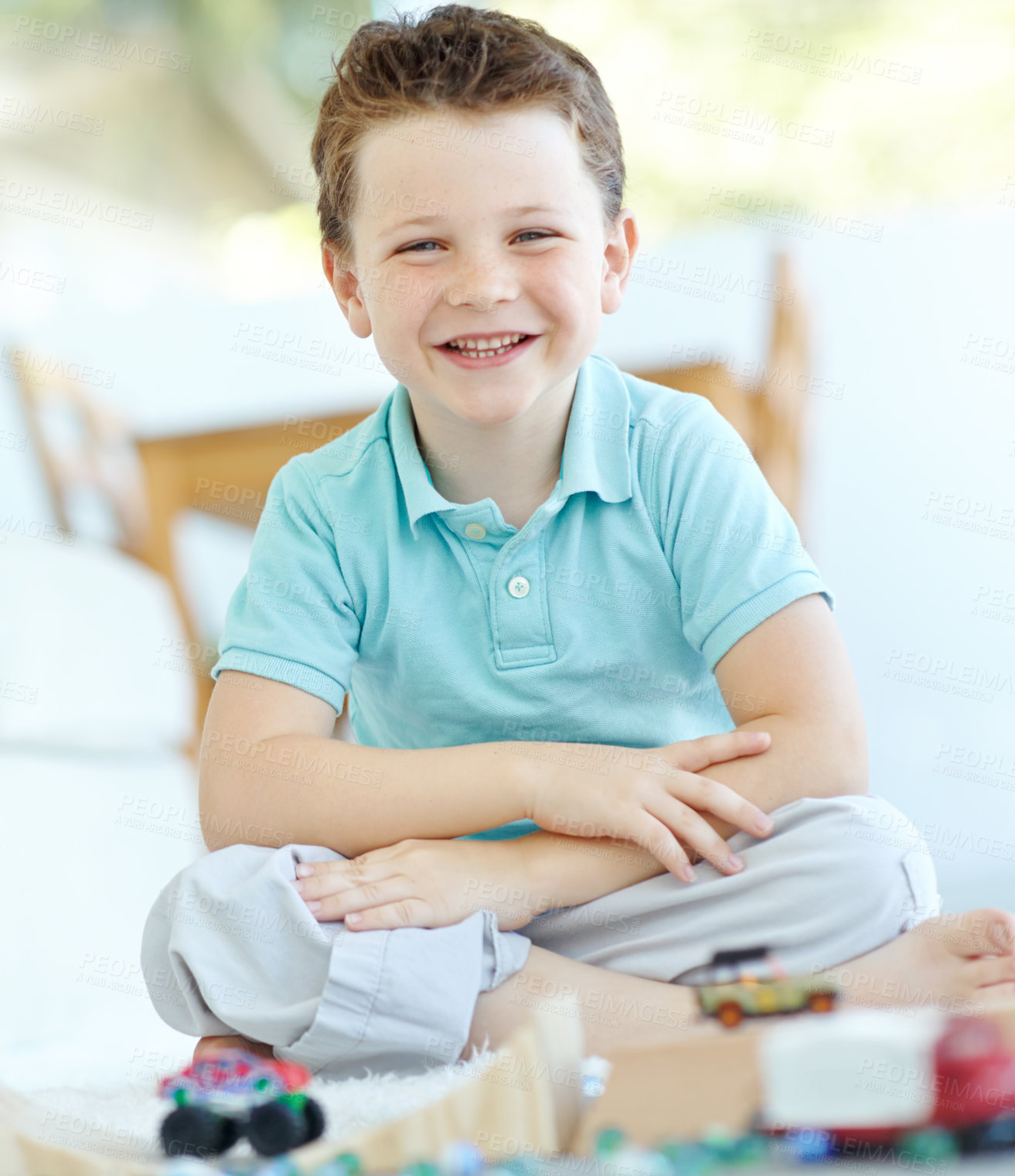 Buy stock photo Home, portrait and happy boy with toys for playing, development and entertainment with kids games. House, child and smile with driving vehicle for fantasy, imagine character or relax for school break